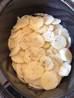 sliced potatoes in a slow cooker with seasoning