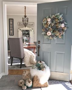 a door with a wreath on it next to a chair and other items in front of the door