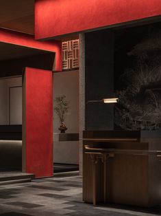 an empty lobby with red walls and black flooring