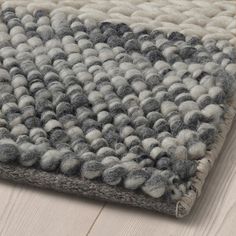 a gray and white rug on the floor