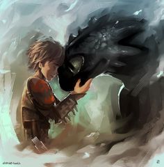 a young boy holding a black dragon in his hand