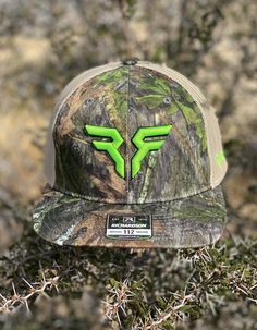 a camo hat with the letter f on it