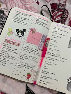 an open notebook with stickers on it and a pink pen in the middle, sitting on a bed