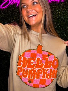 Welcome the season of pumpkin spice with the Hello Pumpkin Chenille Sweatshirt! This comfy crewneck sweater is crafted from cozy chenille fabric and decorated with bright orange and pink. It’s perfect for fall, and everybody needs one! You’ll be the cutest one this season! So what are you waiting for? Get yours now! Unisex sizing and fit SPECIAL CARE - WASHING INSTRUCTIONS: Hand washing and air drying are always best for these items. Wash on delicate, cold, and inside out. Always air dry to prev Cute Brown Sweater For Fall, Cute Graphic Print Sweater For Fall, Brown Graphic Print Sweater For Fall, Pink Graphic Print Sweater For Fall, Cute Orange Fall Tops, Cute Orange Top For Fall, Cute Orange Tops For Fall, Cute Orange Fall Top, Orange Crew Neck Sweatshirt For Fall