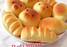 bread shaped like pigs in a blanket with the words roti umyi written on it