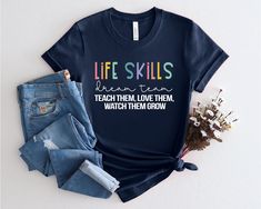 "Life Skills Special Education Teacher Team Gift, Life Skills Teacher Shirt, Life Skills Dream Team, Life Skills Instructor Tshirt PRODUCTION TIME: 1-3 days (Usually 2 days) SHIPPING TIME: 2-5 days (Usually 3 days) DESIGN COLOR: BLACK DESIGN is used by for White, Athletic Heather Pink, Heather Peach, Heather Dusty Blue, Heather Prism Dusty Blue, Lilac. WHITE DESIGN is used by Other Colored Shirts. PRODUCT DESCRIPTION: SOFT T-SHIRT FOR ADULTS AND UNISEX T-shirts are designed and manufactured in the best way possible and made of premium quality ring-spun cotton. The garment (Bella+Canvas) fits perfectly and feels soft and comfortable. The style of the vinyl and the garment can be chosen according to your taste. - For the best quality materials, we offer very fast dispatching and posting serv Life Skills Teacher Shirts, Teach Like A Champion, Teacher Costumes, Education Shirts, Life Skills Special Education, Teacher Team, Lilac White, Blue Lilac, Special Education Teacher