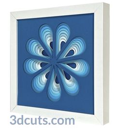 a blue and white paper art piece in a frame