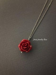 Dark red rose necklace. Red rose is on a delicate but sturdy 18'' stainless steel chain with lobster clasp. If you choose to add initials, please leave the initials in order left to right in the note to sellers box during checkout. *Necklace is available with 1,2 and 3 leaves *15mm Resin rose *Silver plated brass leaves *Stainless steel chain *Handmade with love <3 Like Jmesjewelrybox on Facebook for updates on new jewelry, upcoming sales and giveaways! Plus Facebook fans save 5% :D Find the Valentine's Day Flower Pendant Jewelry With Rose Design, Valentine's Day Rose Design Flower Pendant Jewelry, Dainty Red Flower Necklace, Red Rose Necklaces For Gifts, Red Roses Necklaces For Gift, Gift Red Rose Necklaces, Red Rose Necklace For Gift, Red Flower Necklace With Rose Design, Rose Sterling Silver Jewelry For Valentine's Day