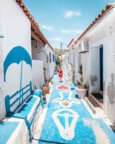 an alleyway with painted blue and white buildings