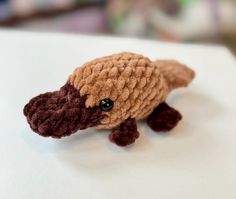 a small crocheted turtle sitting on top of a table