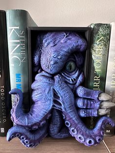 an octopus bookend made out of books on a shelf