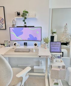 a white desk with a computer monitor and keyboard