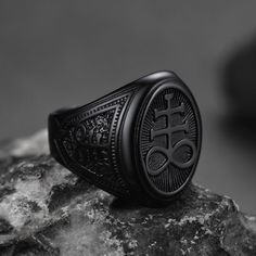 a black ring sitting on top of a rock