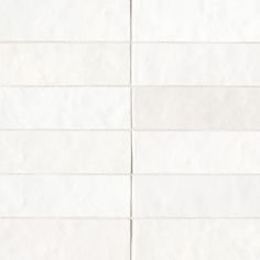 a white tiled wall with lines drawn on the bottom and one line in the middle