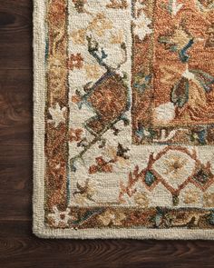 an area rug on top of a wooden floor with a brown and blue border around it