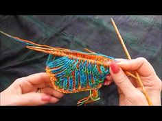 two hands are holding yarn and knitting needles