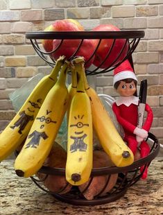 an elf is sitting in a basket with bananas