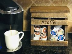 a coffee maker and some cups on a counter