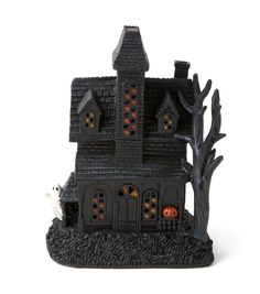 a black and white house with pumpkins on it