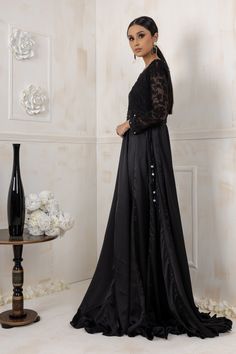 Black beauty gown bodice is made on machine floral embroidery net, which is followed by handwork of black sitara, crystals, beads work with an enchanting full length silk gown paired with khadi net dupatta with beads on border to give a royal look. Color: Black Shirt: khadi net and silk Dupatta Khadi Net Shirt length: 64” All outfits are fully lined Lining in sleeves is complimentary just mention in custom text box if needed Please refer size guide before selecting size For customized measuremen Party Anarkali Set With Pearl Embroidery In Organza, Party Organza Anarkali Set With Pearl Embroidery, Semi-stitched Evening Dress With Sheer Dupatta, Anarkali Evening Dress With Resham Embroidery For Wedding, Floor-length Georgette Dress With Pearl Embroidery, Evening Semi-stitched Organza Lehenga, Evening Organza Semi-stitched Lehenga, Floor-length Pearl Embroidered Gown For Eid, Floor-length Gown With Pearl Embroidery For Eid