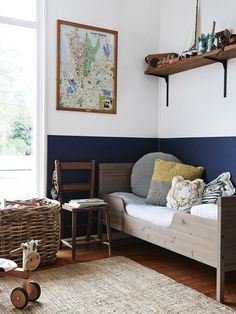 an image of a bedroom with blue walls and wood furniture on the bottom shelf, along with a white rug