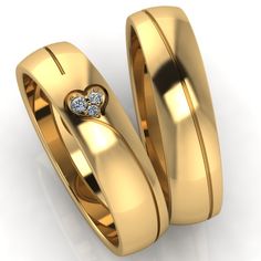 two gold wedding rings with diamonds on them