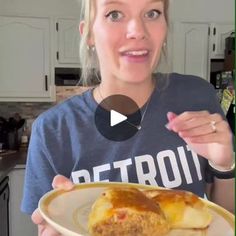 a woman holding a plate with some food on it