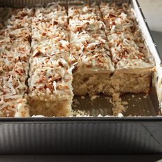 there is a cake that has been cut into pieces and sitting in a pan on the table