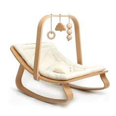 a wooden rocking chair with a white cushion on the bottom and an image of a cloud hanging from it