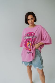 Pink and perfect! Loving this oversized Daydreamer shirt! Made from a 100% cotton fabric, feels like a luxury tour shirt with the perfect drape Exaggerated oversized tee that can be worn baggy with denim or perfect with a pair of bike shorts Model is 5'0" and normally wears a size small. The length of this top measures 28". Fits sizes X-Small-XL. Oversized Retro T-shirt For Spring, Short And Oversized Shirt Outfit, Oversized Trendy Summer Top, Oversized Trendy Top For Summer, Oversized Graphic Tee For Day Out, Relaxed Fit Screen Print Top For Day Out, Relaxed Fit Top With Screen Print For Day Out, Oversized Trendy Cotton Tops, Oversized Screen Print T-shirt For Day Out