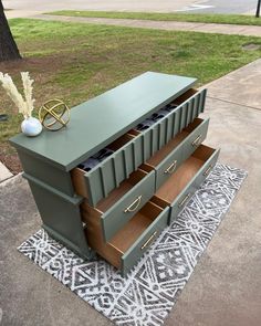 a green dresser sitting on top of a rug