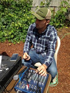 a man sitting in a chair next to an electronic device