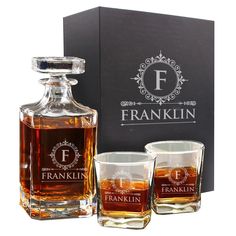 two shot glasses and a decanter in front of a black box with the franklin logo on it