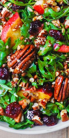 a salad with apples, cranberries and pecans