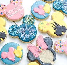 mickey mouse and minnie mouse cookies on a white table with the words happy birthday written on them