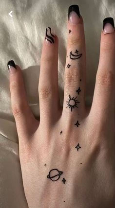 a woman's hand with some tattoos on it