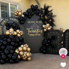 an outdoor memorial display with balloons and decorations