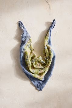 a blue and yellow scarf hanging on a wall