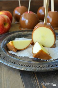 caramel apples on a plate with toothpicks in them