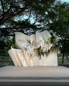 a large white sculpture with flowers on it