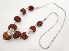 Navgrah Rudraksha Beads Kantha Mala- (Siddha mala) is a Powerful and unique Rudraksha Navagraha Kantha. This Navgrah Rudraksha Beads Kantha consists of Rudrakshas from 2 Mukhi to 9 mukhi (1 each) + 12 Mukhi. There is a silver chain attached to the pendant. This Siddh Mala Silver Pendant appease all the negative planets and gives power to benefic planets. Navgarh Rudraksha kantha is the one pendant, which should definitely be worn by everyone. It does not have any negative effect. It would defini Spiritual Silver Beaded Necklaces For Puja, Spiritual Necklaces With Silver Beads For Puja, Rudraksha Jewelry, 9 Planets, Rudraksha Beads, Silver Caps, Mala Necklace, Prayer Beads, Beaded Pendant