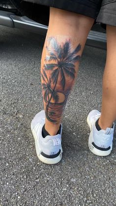 a person with a palm tree tattoo on their leg