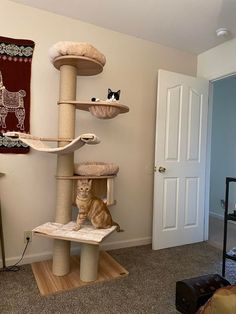 a cat sitting on top of a scratching tower