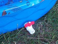 an inflatable toy boat sitting on the grass