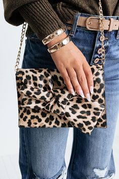 You will look as chic as a celebrity when you carry this eye-catching clutch featuring a bold black leopard print with a large bow accent, a flap closure with snap buttons, a removable gold chain link shoulder strap, and a spacious fully lined interior! Cheetah Bag, Leopard Handbag, Purse Outfit, Leopard Clutch, Black Leopard Print, Large Bow, A Celebrity, Black Leopard, Bold Black