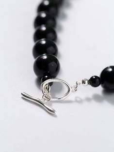 Experience the bold and versatile beauty of our 14mm Black Onyx Beaded Necklace with OT Buckle. This uniquely crafted necklace features large black onyx beads and an OT clasp, creating a statement piece that effortlessly combines boldness with contemporary style. Metal: Recycled Sterling Silver Plated On Brass Gemstone: Black onyx 14mm Length: 420mm Weight: 105g Buckle Necklace, Edison Pearls, Gemstone Beaded Necklace, Onyx Bead, Tiger Eye Stone, Brass Material, Recycled Sterling Silver, Ring Bracelet, Stone Necklace