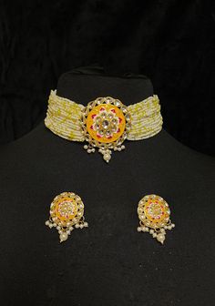 Indian Ladies' Pearl Choker & Earrings of Kundan & Pastel Yellow Meenakari Work Contemporary Indian bridal set with multilayered pearl strands choker and studded earrings. This bridal choker jewelry set is accented with yellow pastel meenakari pendant and Kundan gemstones making it one of a kind. Gold plated choker with cluster pearls drops adorns this bridal necklace.  This modern choker is sure to make you feel like a million bucks with its elaborating multiple pearl strands in a handcrafted d Elegant Yellow Meenakari Jewelry, Yellow Sets With Meenakari For Diwali, Yellow Round Meenakari Jewelry, Festive Yellow Meenakari Jewelry, Yellow Ceremonial Necklace For Festive Occasion, Yellow Round Temple Jewelry, Ceremonial Yellow Jewelry For Festivals, Traditional Yellow Ceremonial Jewelry, Yellow Temple Jewelry With Meenakari