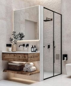 a bathroom with a sink, toilet and shower stall in the middle of it's walls