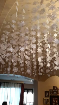 the ceiling has snowflakes on it and is decorated with white frosted flowers