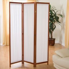 the room divider is made out of wood and white fabric